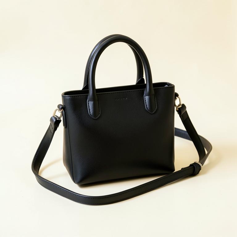 Small black leather mini tote with top handles and crossbody strap