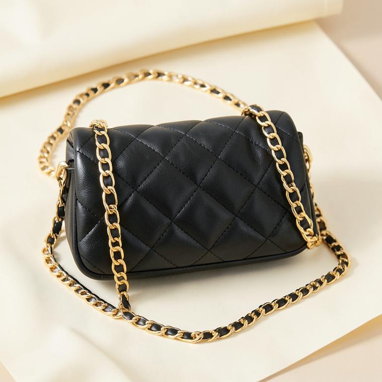 Black quilted leather evening bag with gold chain strap