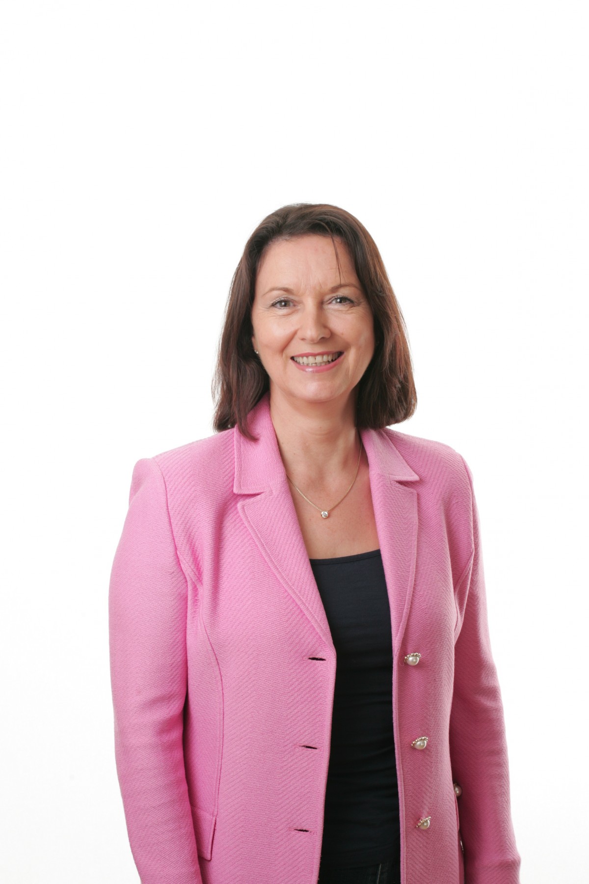 Woman wearing a pink blazer with a casual white top, styled as inspiration for nine Pinterest-trending blazer outfits