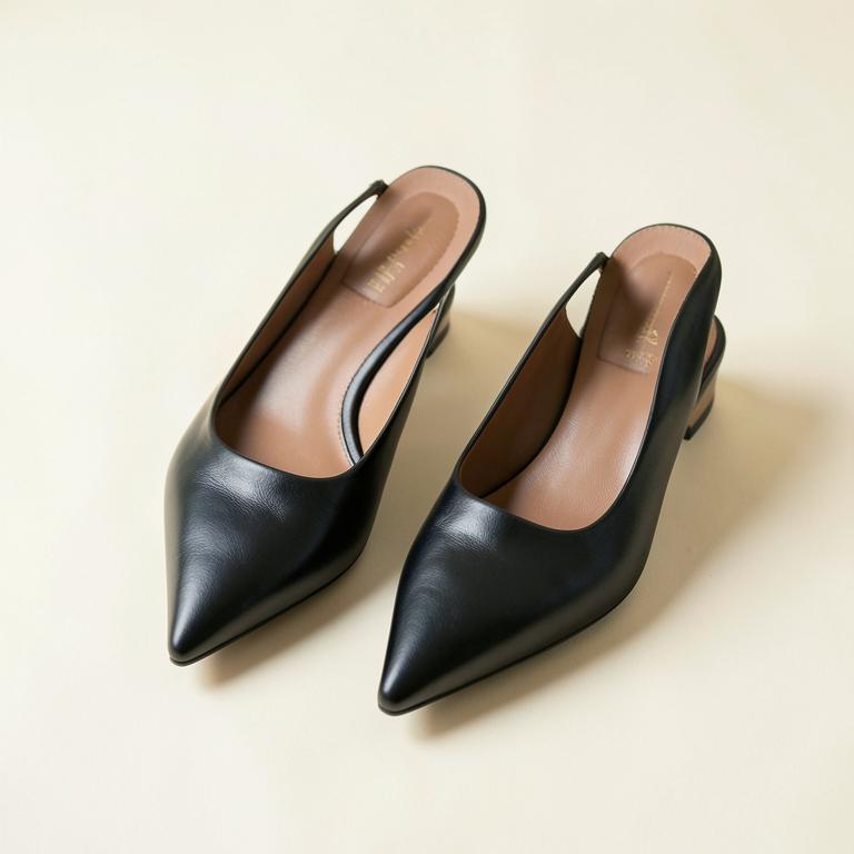 Black pointed-toe leather slingback flats